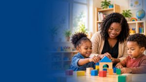 A childcare provider building with wooden blocks alongside two young children at a classroom table